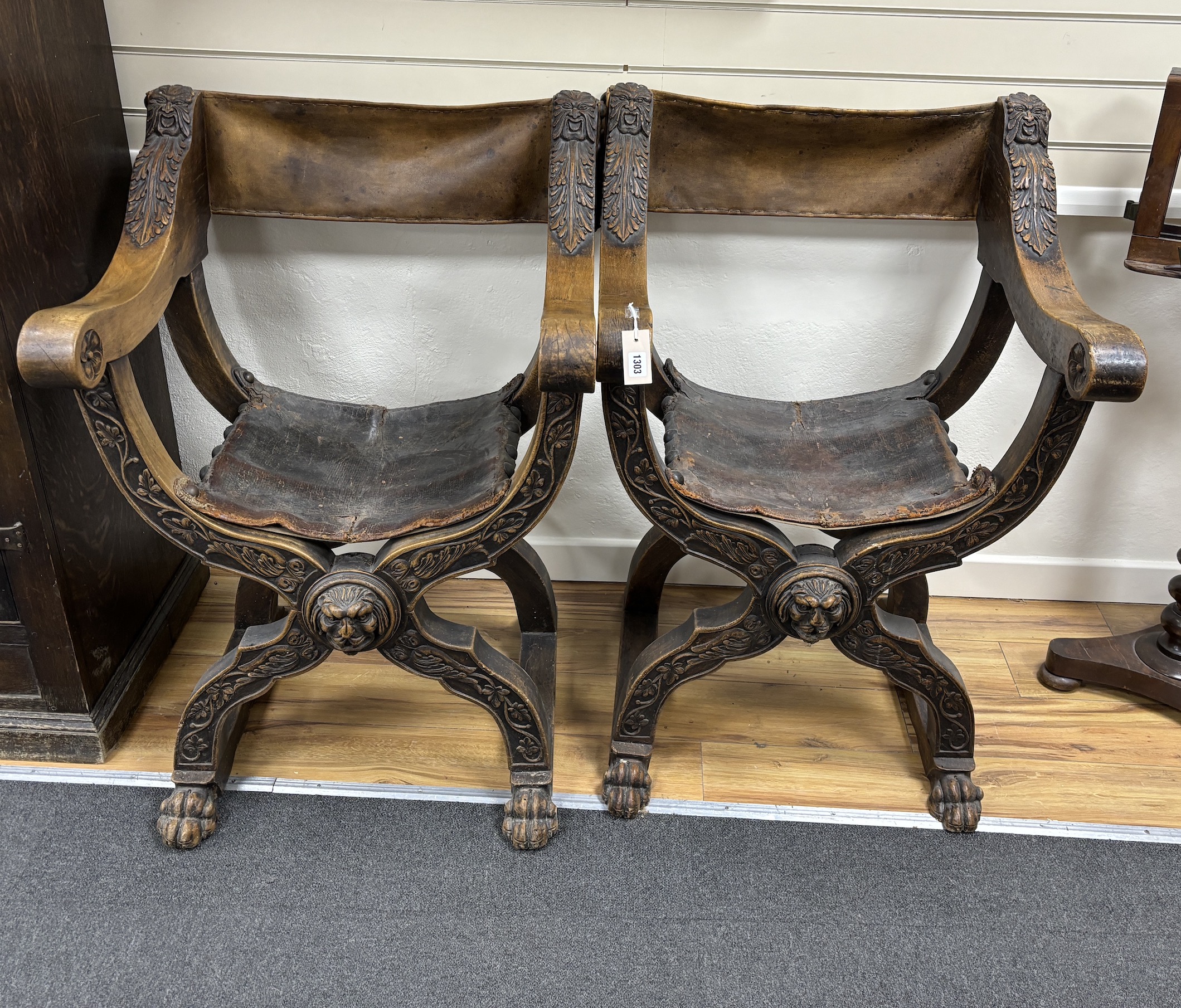 A pair of 19th century Italian Savonarola ‘’X’’ framed elbow chairs, with leather backs and seats, width 72cm, height 104cm, Please note this lot attracts an additional import tax of 5% on the hammer price